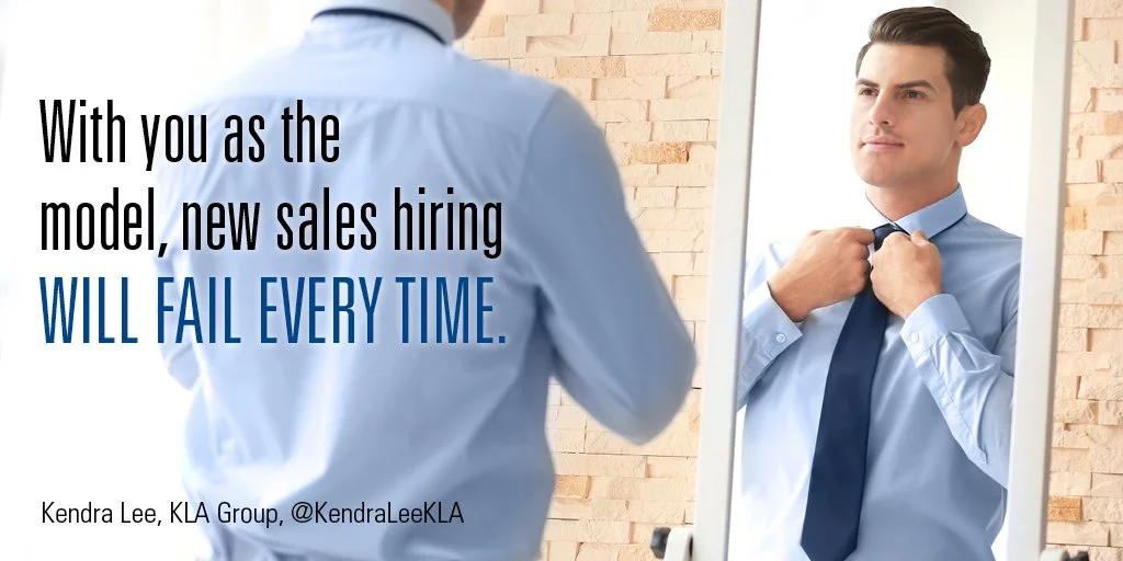 Salesperson in blue dress shirt looking in mirror while happily straightening his tie