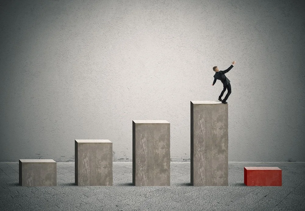 Businessman about to fall after experiencing business growth